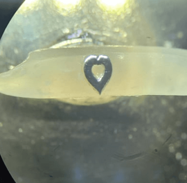 Micro Art. Heart on a grain of rice. Micro miniature.